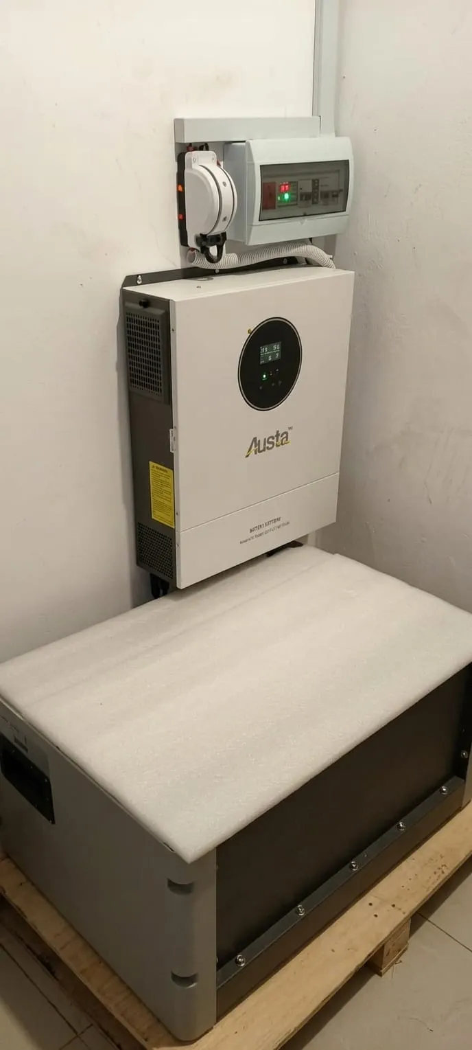 Wall-mounted hybrid inverter above a lithium battery unit in a utility room