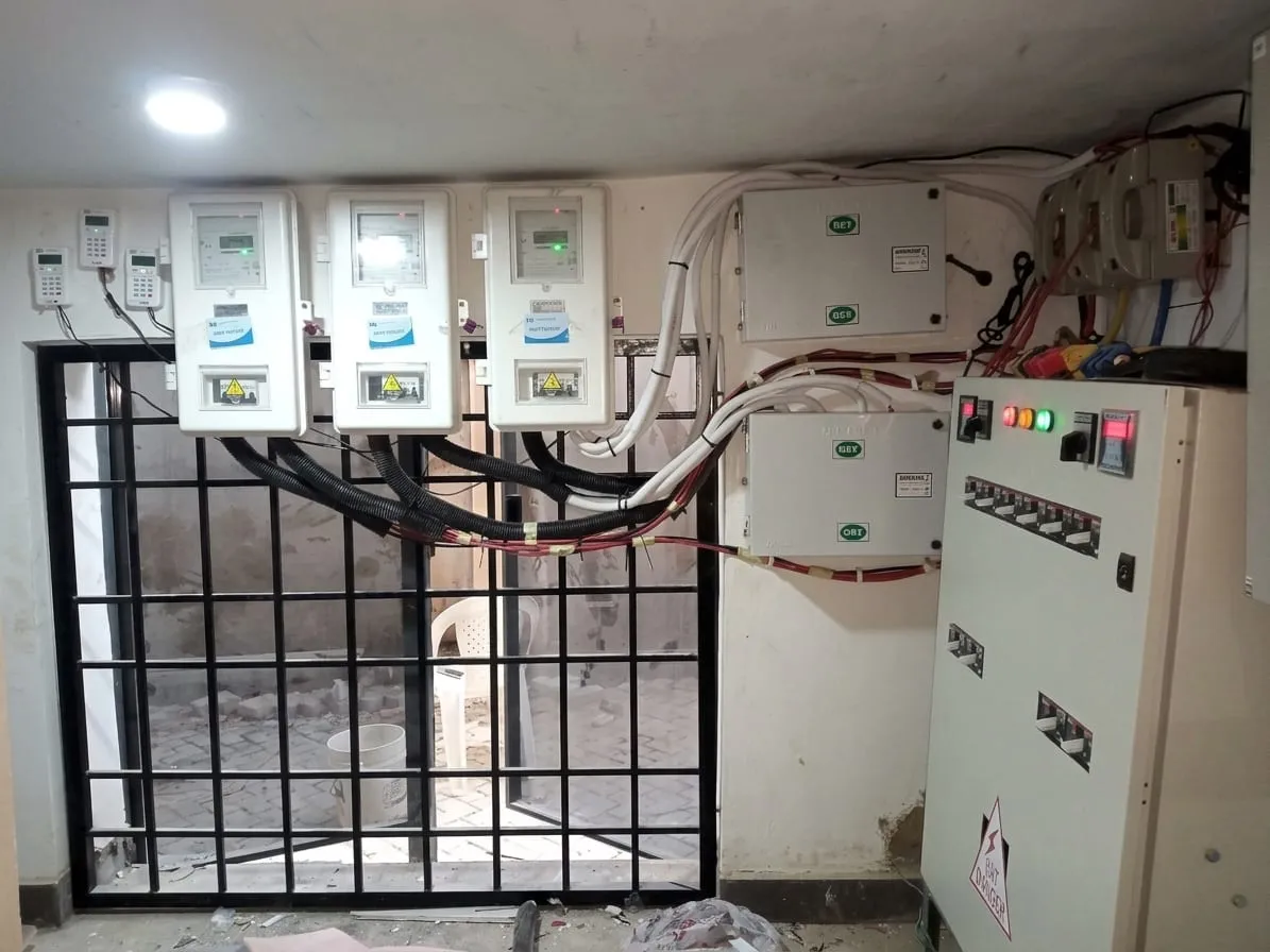 Row of prepaid electricity meters and distribution panels in a meter room