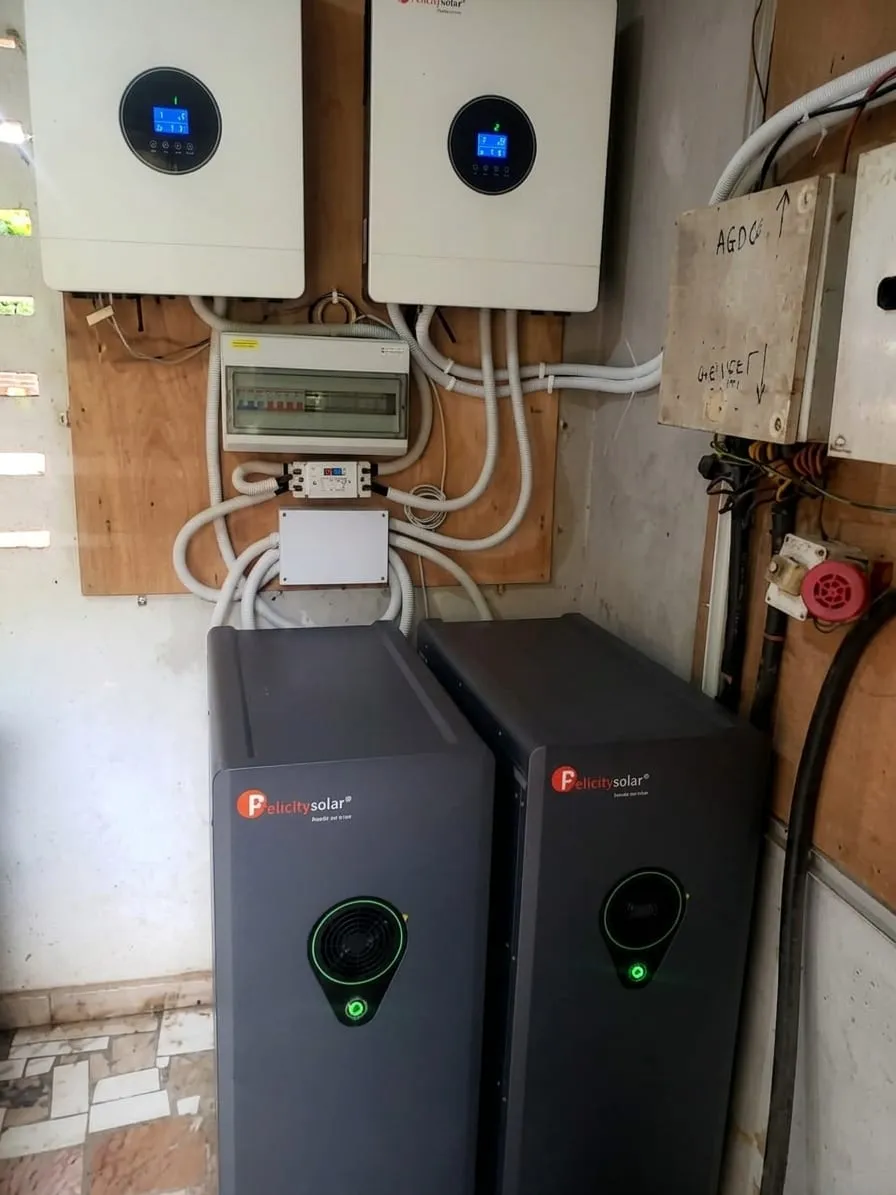 Two tower inverters below wall-mounted inverters and a distribution board
